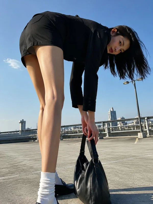 Adult-presenting fictional portrait for aipornimagetovideo.com: low gaze portrait east asian woman urban commuter